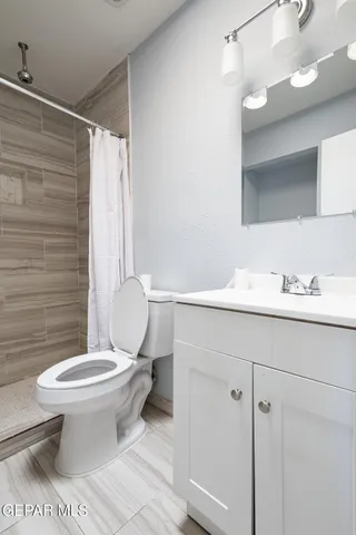a bathroom with a toilet and a shower