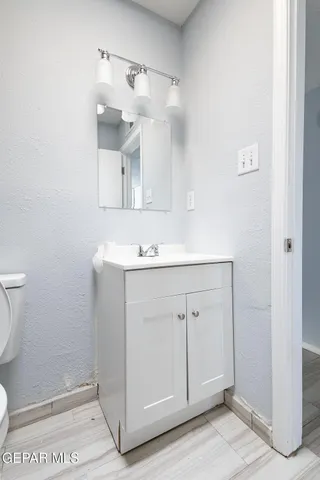 a view of an empty room with a window and a ceiling fan