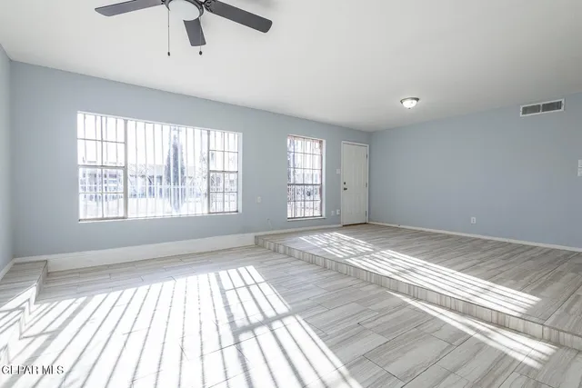 a view of a bedroom with wooden floor