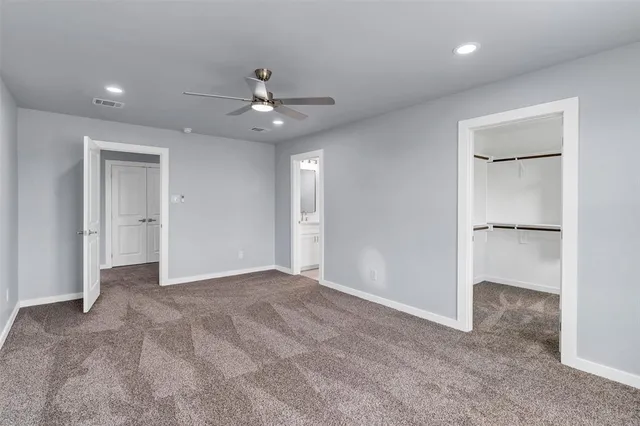 a view of an empty room with a ceiling fan