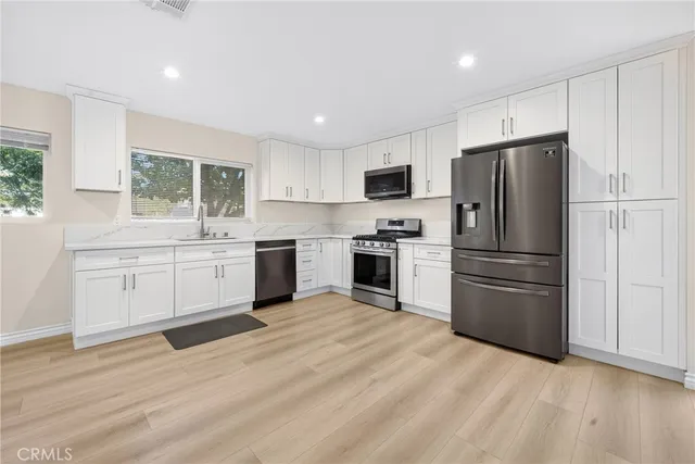a view of kitchen with sink microwave and stove