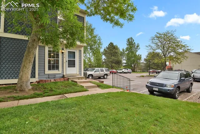 a house view with a sitting space and garden