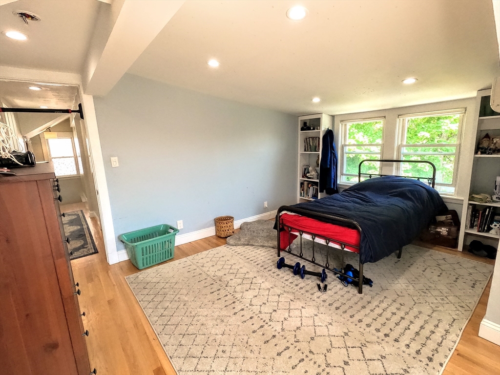 12 Searle Road, Unit 12 Boston, MA 02132 - Photo 31 of 35 a bedroom with furniture and a flat screen tv