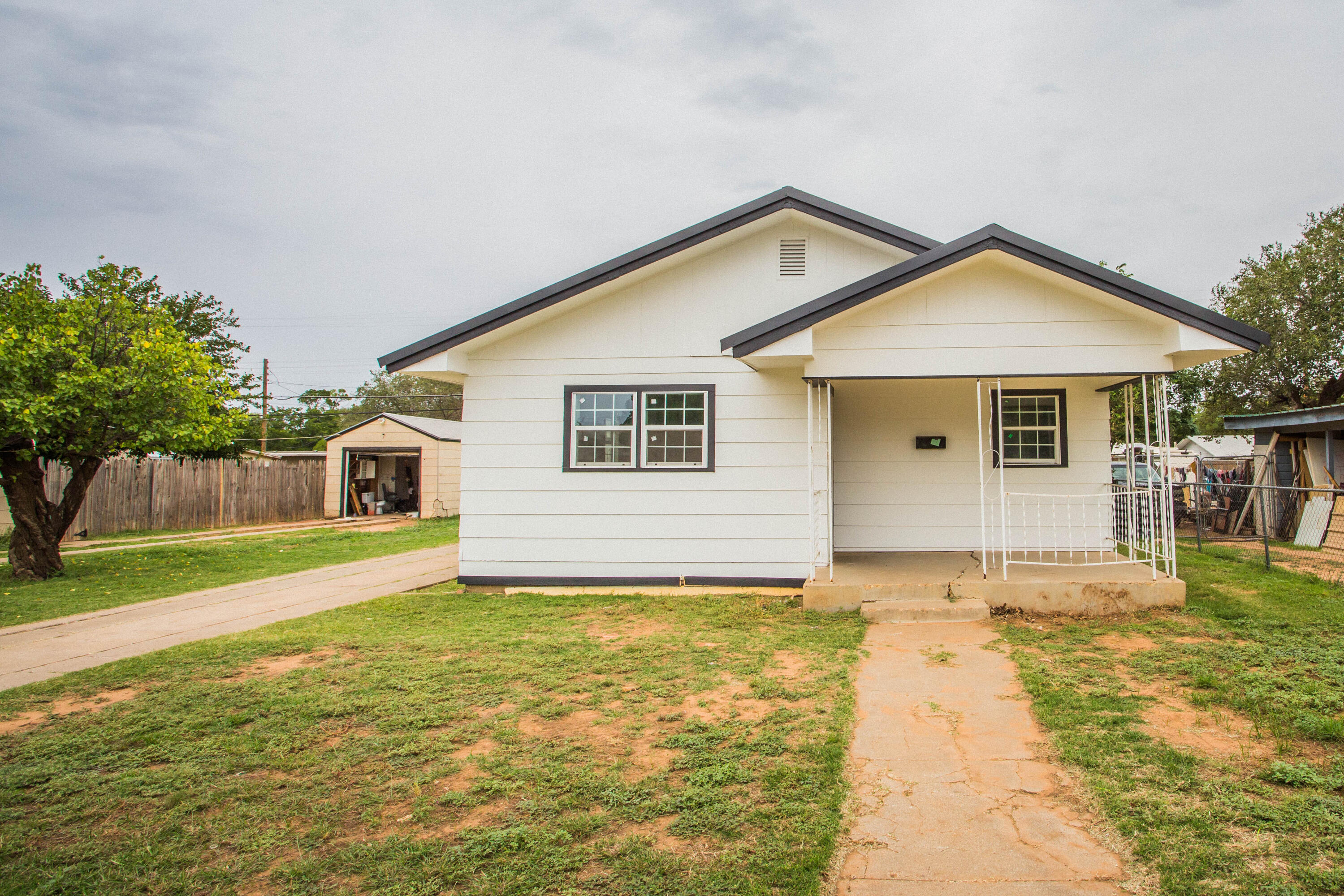 3012 39th Street Lubbock, TX 79413 - Photo 1 of 31 a front view of house with yard and trees in the background