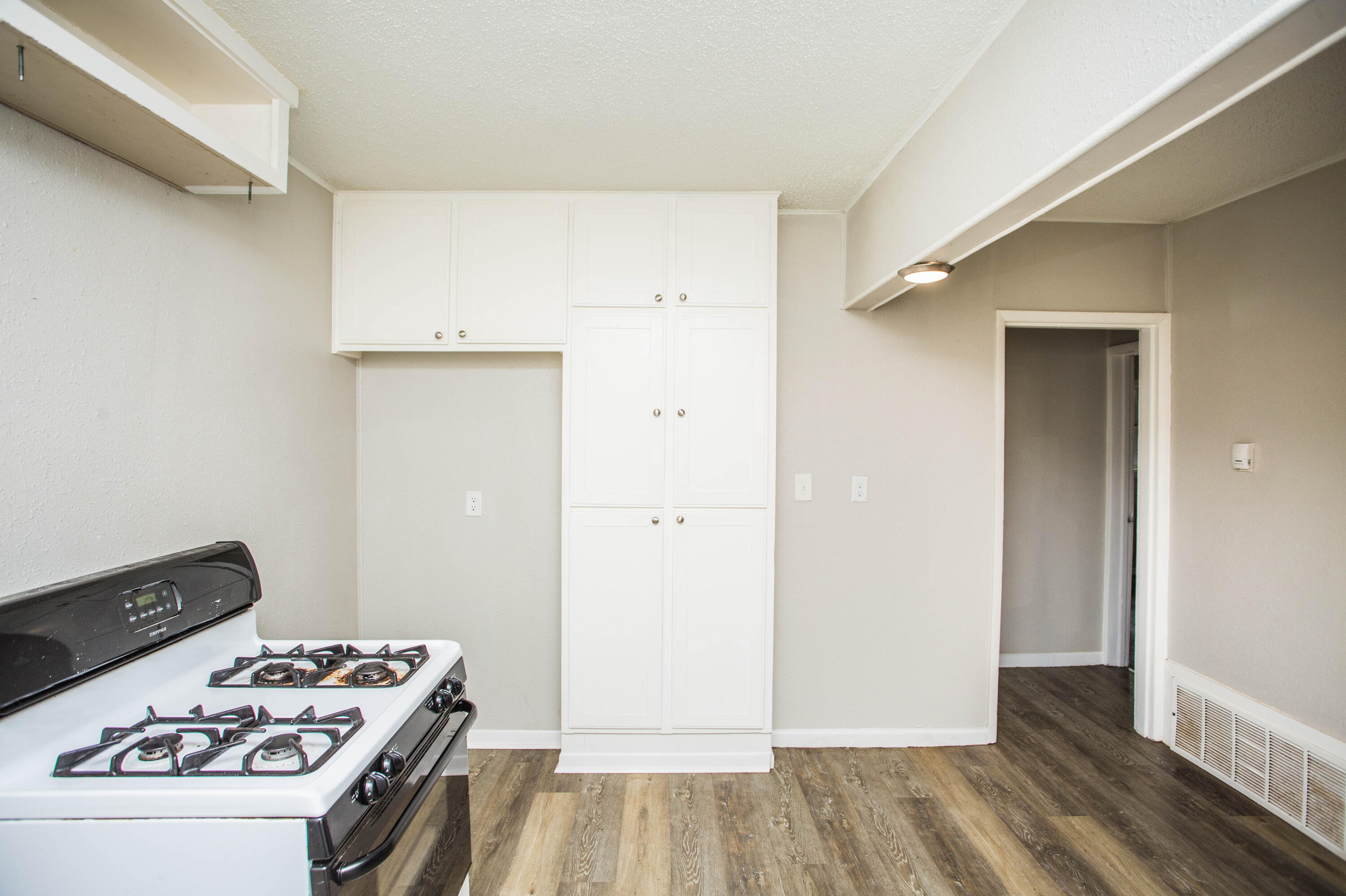 3012 39th Street Lubbock, TX 79413 - Photo 12 of 31 a kitchen with a stove and a refrigerator