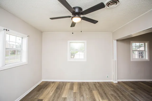 wooden floor in an empty room with a window