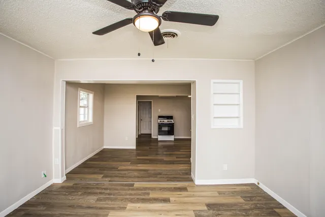 wooden floor in an empty room with a window