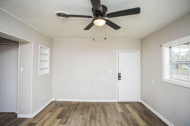 wooden floor in an empty room with a window