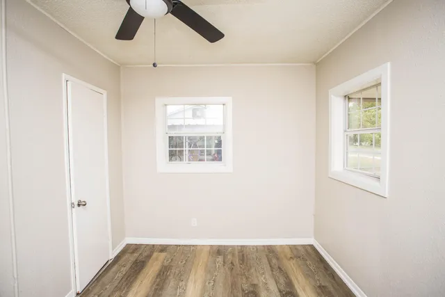 wooden floor in an empty room with a window