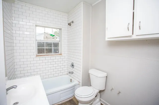 a bathroom with a toilet a sink and bathtub