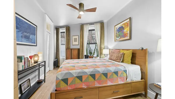 a bedroom with a bed next to a window