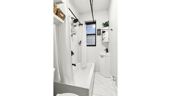 a bathroom with a shower and a mirror