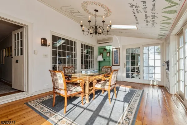 a view of a dining room with furniture wooden floor and chandelier
