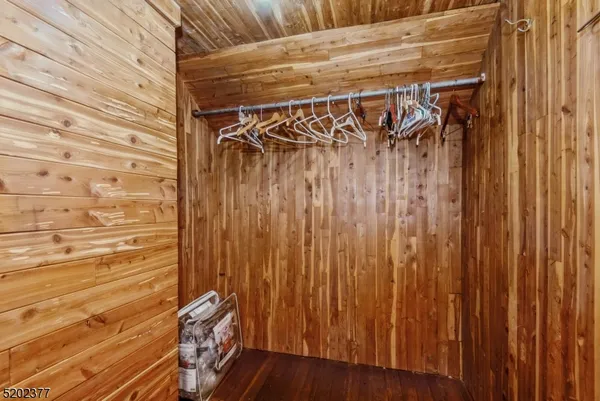 a view of walk in closet with clothes