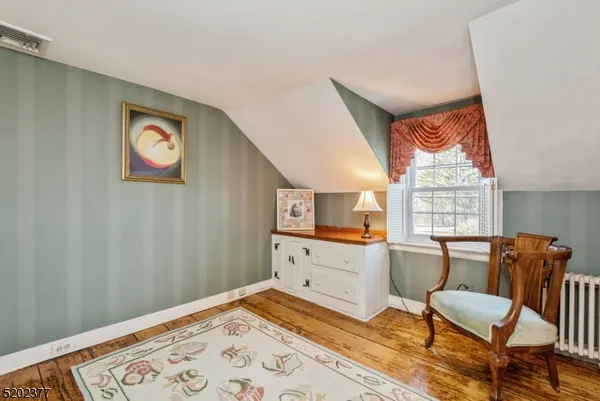 a workspace with wooden floor and a window