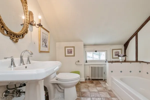a bathroom with a sink a toilet and bathtub