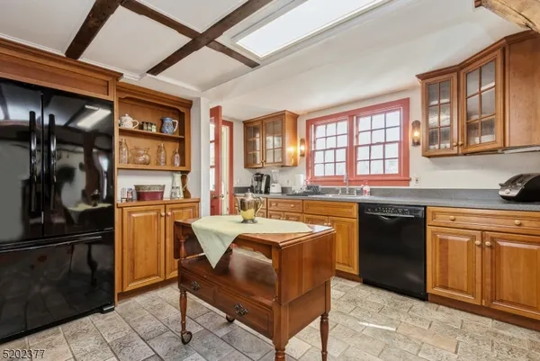 a large kitchen with stainless steel appliances granite countertop a stove a sink dishwasher and a refrigerator