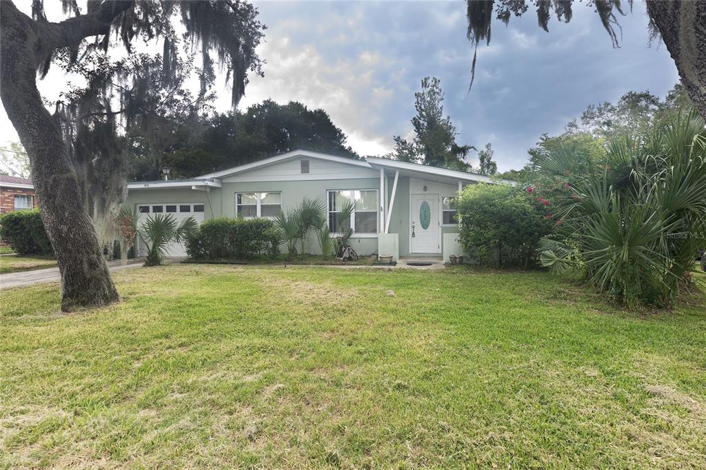 a front view of house with yard and green space