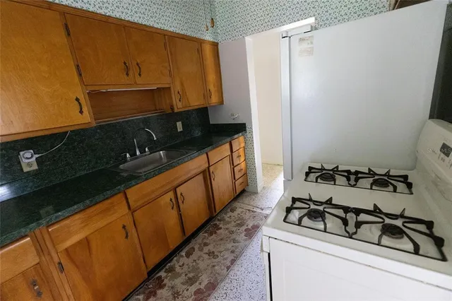 a kitchen with sink window and white cabinets