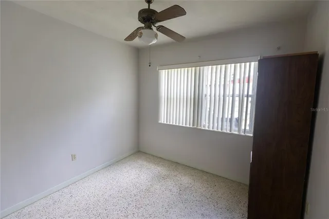 a view of room with a ceiling fan and window
