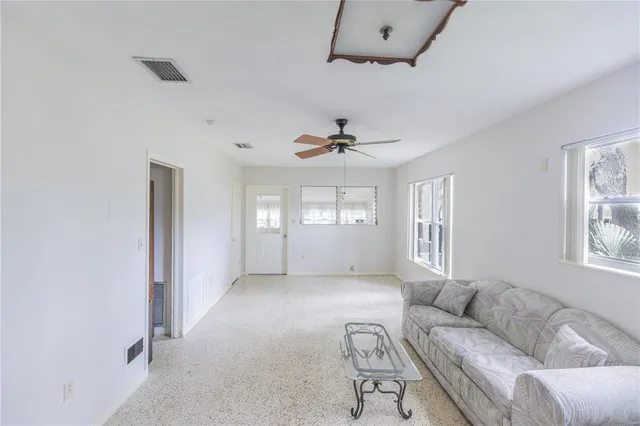 a living room with furniture and windows