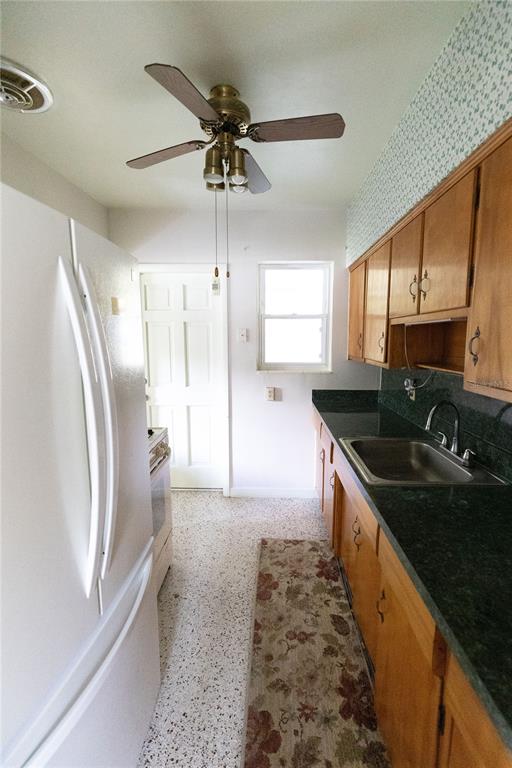 1010 Glen Ridge Drive Leesburg, FL 34748 - Photo 9 of 24 a kitchen with stainless steel appliances granite countertop a sink a stove and a refrigerator