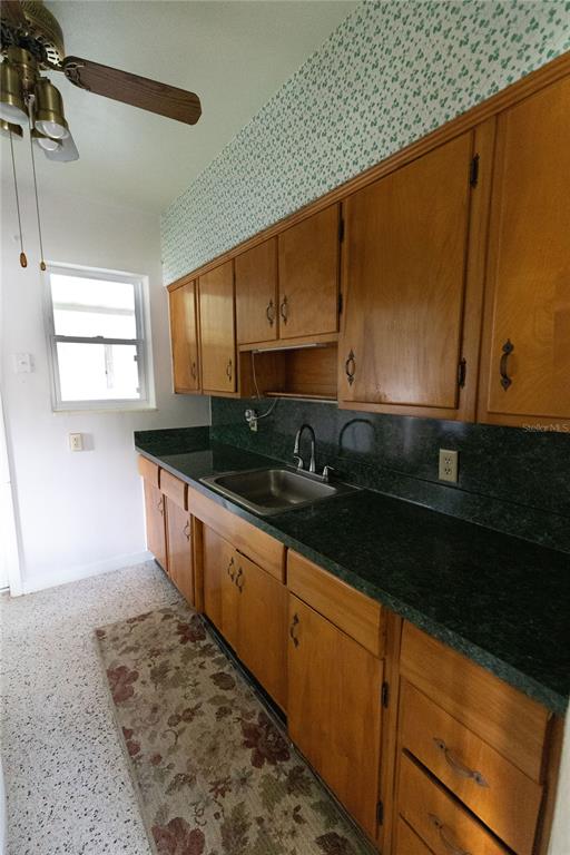 1010 Glen Ridge Drive Leesburg, FL 34748 - Photo 10 of 24 a kitchen with granite countertop sink cabinets and black stainless steel appliances