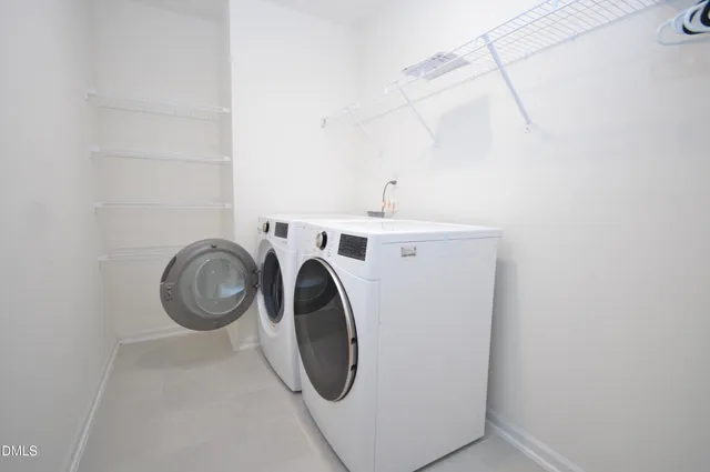a view of walk in closet with clothes
