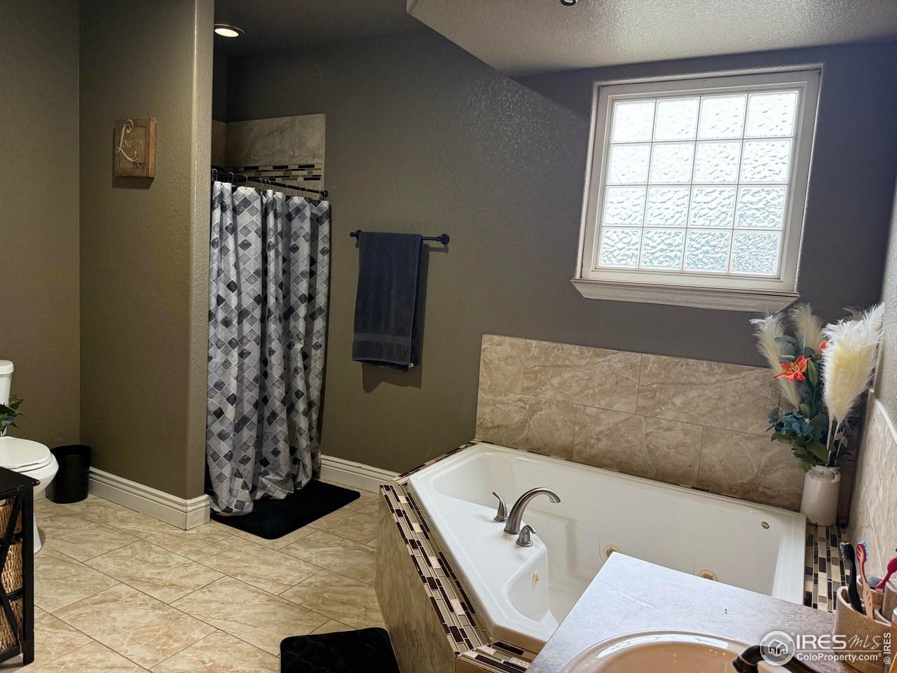 419 East 3rd Avenue Wiggins, CO 80654 - Photo 11 of 20 a bathroom with a tub sink and shower