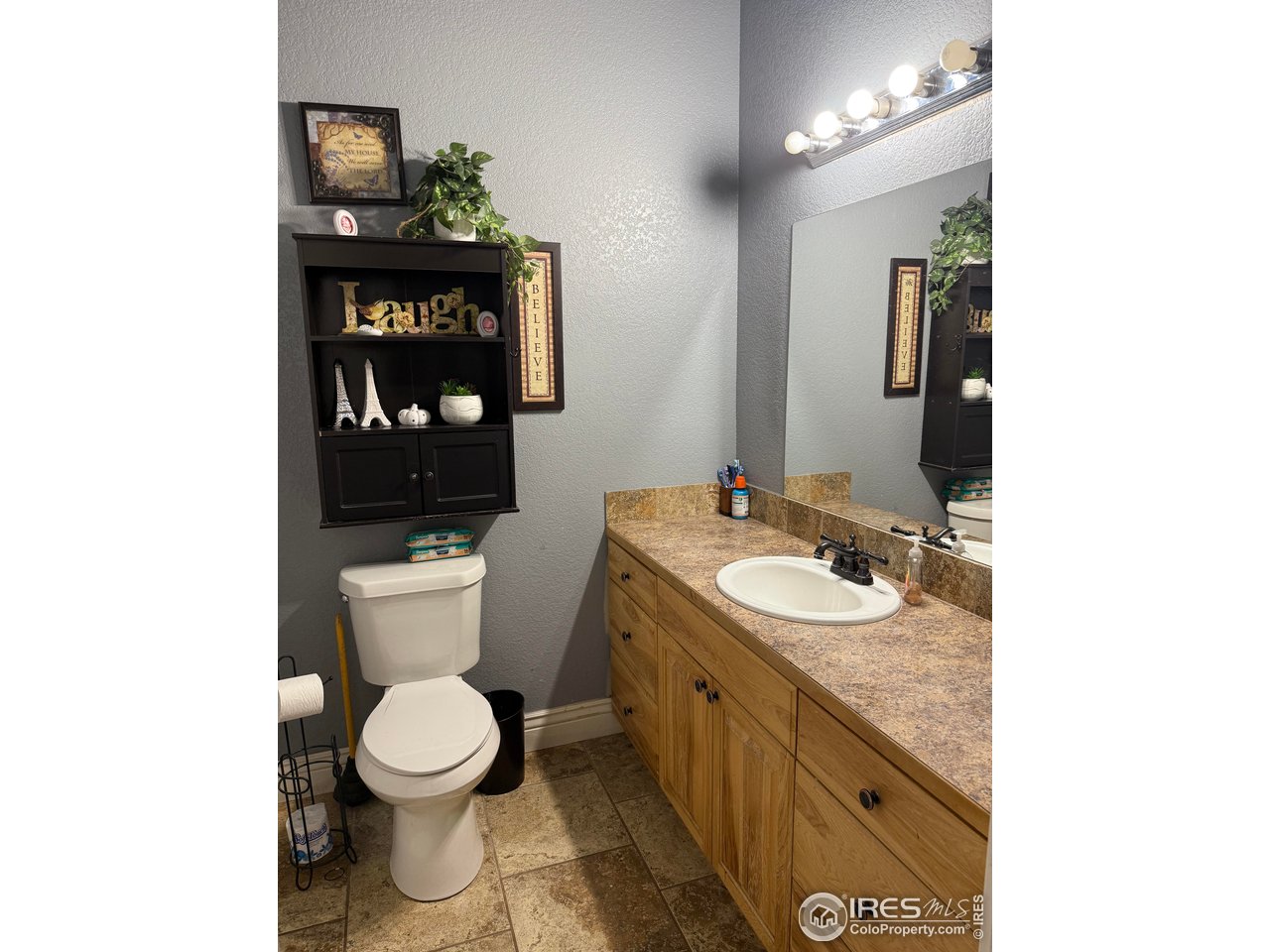 419 East 3rd Avenue Wiggins, CO 80654 - Photo 15 of 20 a bathroom with a toilet sink and mirror