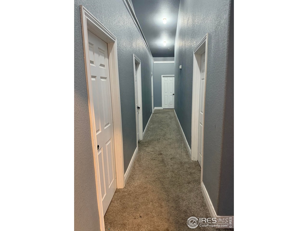 419 East 3rd Avenue Wiggins, CO 80654 - Photo 18 of 20 a view of a hallway with wooden floor