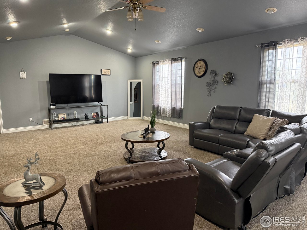 419 East 3rd Avenue Wiggins, CO 80654 - Photo 2 of 20 a living room with furniture and a flat screen tv