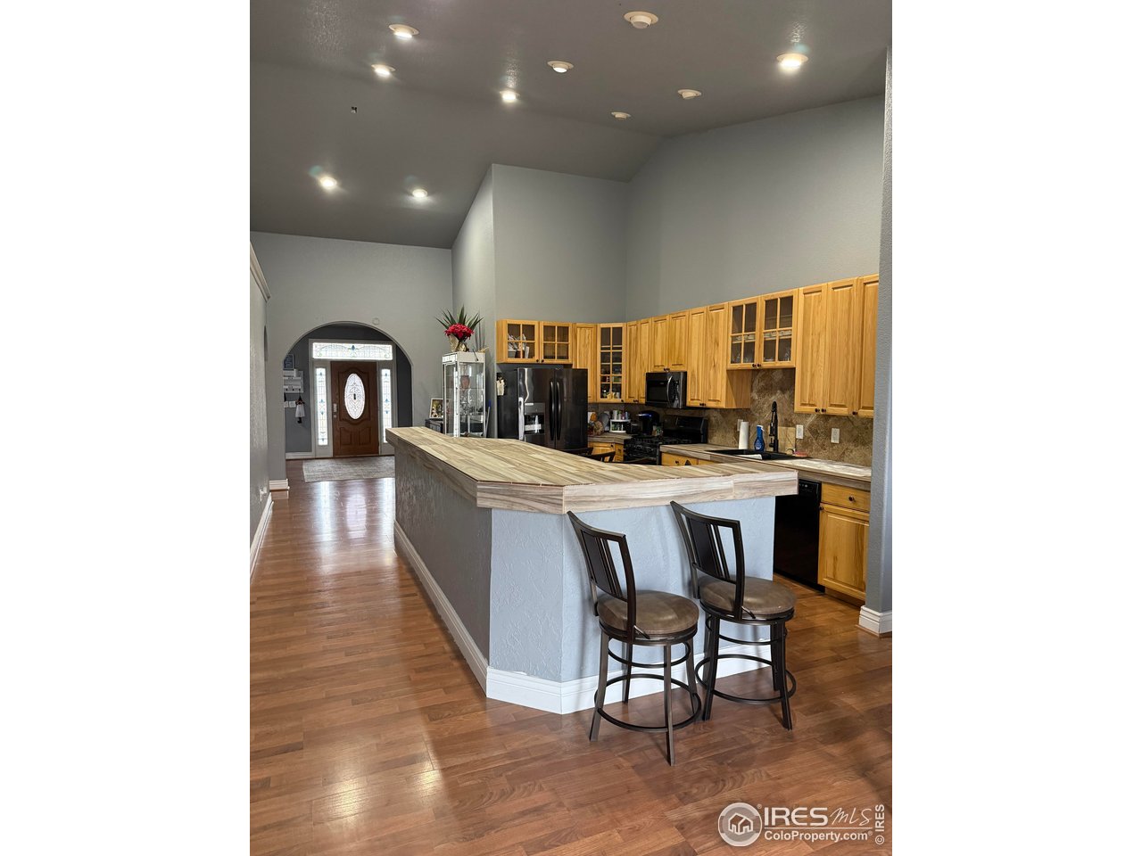 419 East 3rd Avenue Wiggins, CO 80654 - Photo 7 of 20 a dining room with kitchen island stainless steel appliances a table and chairs