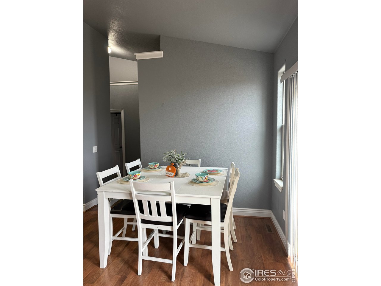 419 East 3rd Avenue Wiggins, CO 80654 - Photo 8 of 20 a view of a dining room with furniture and wooden floor