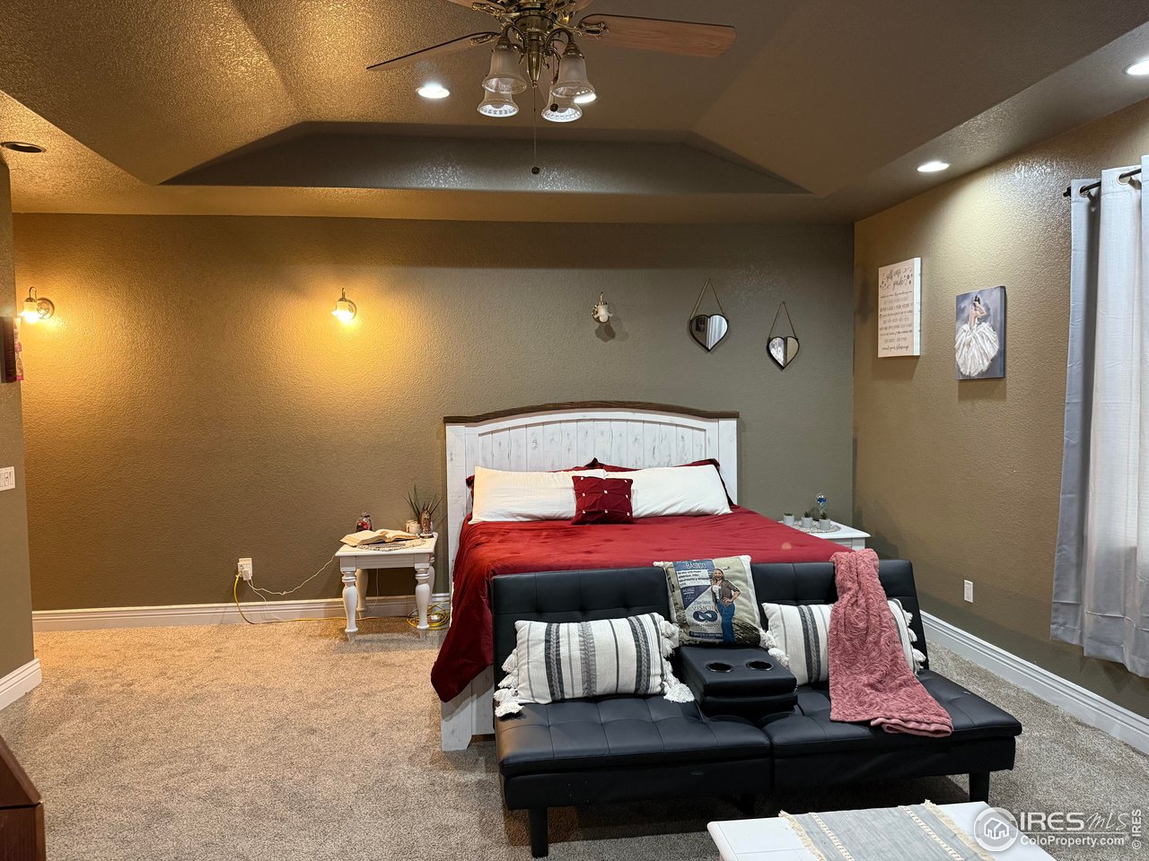 419 East 3rd Avenue Wiggins, CO 80654 - Photo 9 of 20 a bedroom with a bed and lamp