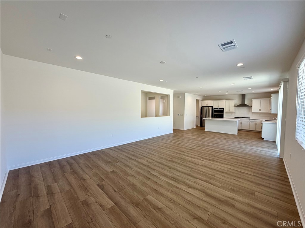 21624 Thomas Court Riverside, CA 92507 - Photo 4 of 36 a view of kitchen and hall with wooden floor