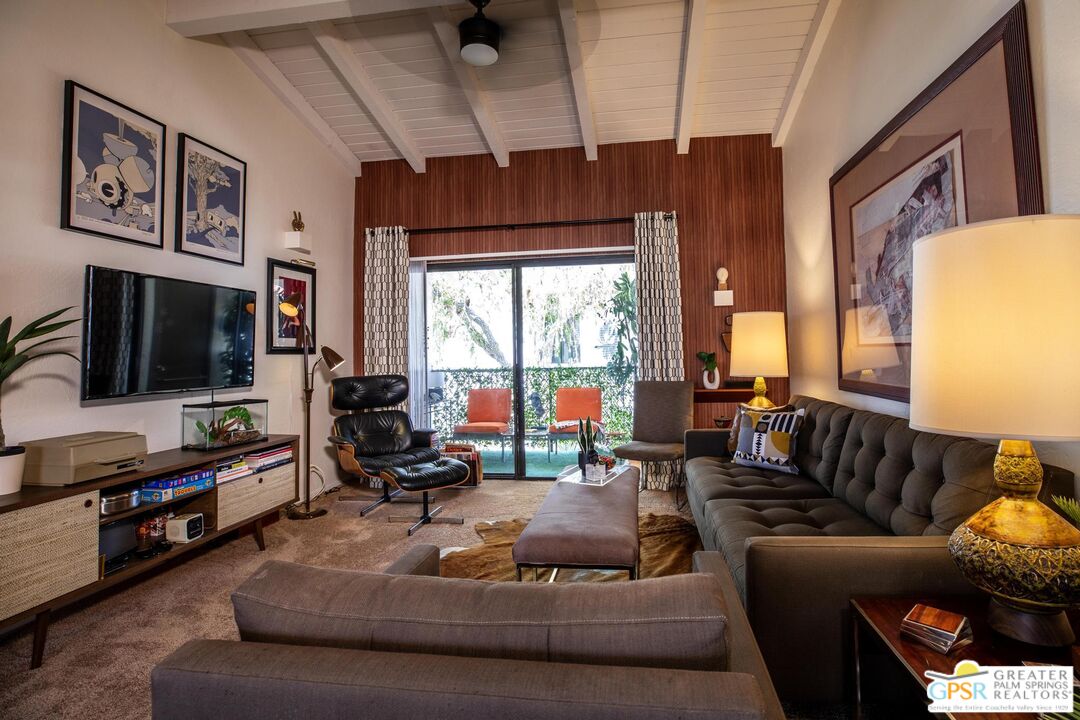 1050 Ramon Road, Unit 34 Palm Springs, CA 92264 - Photo 7 of 10 a living room with furniture and a flat screen tv