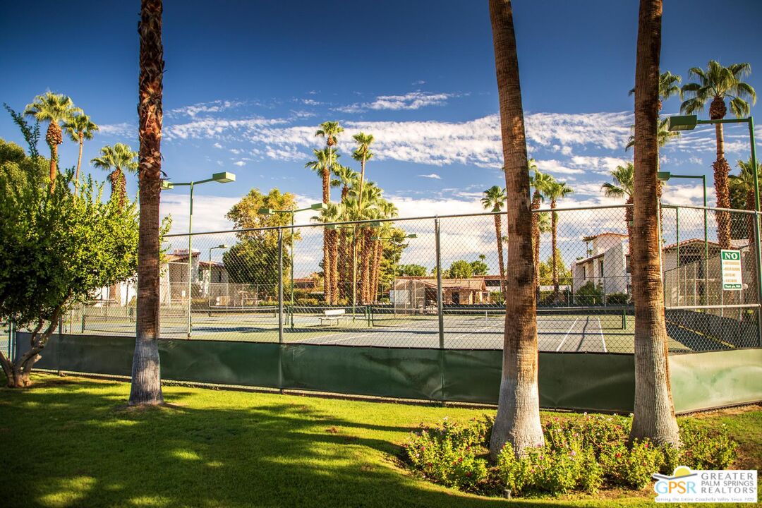 1050 Ramon Road, Unit 34 Palm Springs, CA 92264 - Photo 10 of 10 a view of a swimming pool with a lawn chairs next to yard