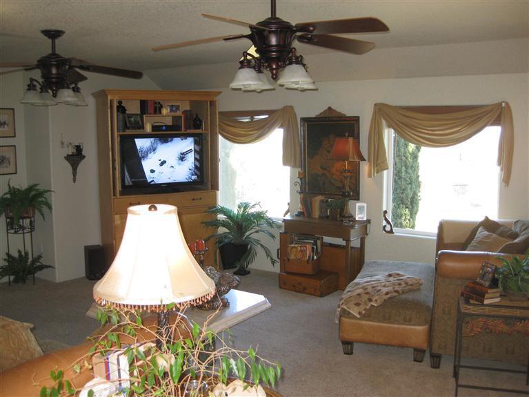 3155 Old Stage Road Central Point, OR 97502 - Photo 17 of 24 a living room with furniture a chandelier and a flat screen tv