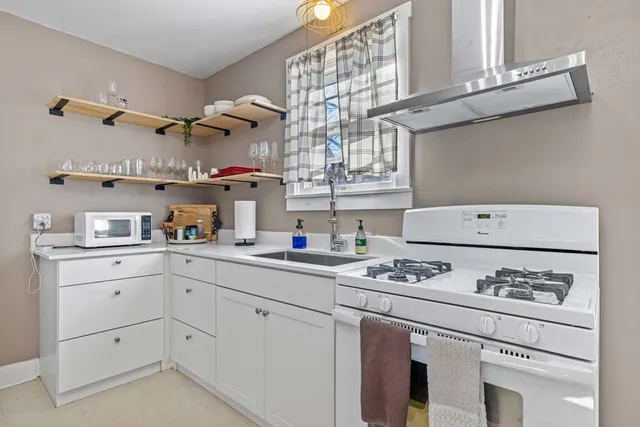 a kitchen with appliances cabinets and a table