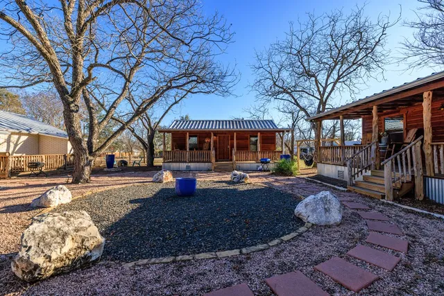 a view of a house with backyard and sitting area