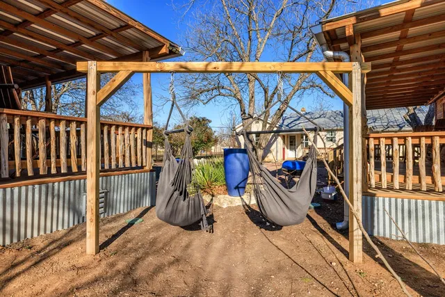 a view of a yard with wooden fence