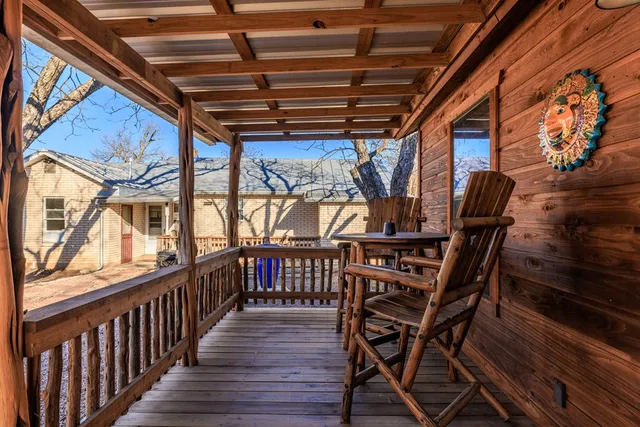 a view of a porch with wooden floor