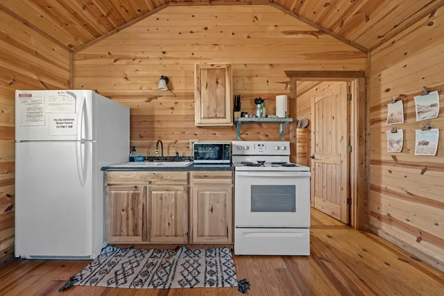 a bathroom with a toilet a sink and shower