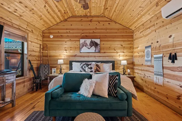 a bed room with furniture and a flat screen tv