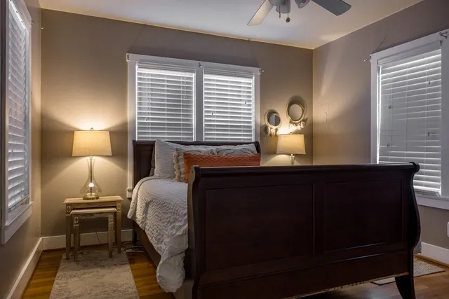 a bed sitting in a bedroom next to a window