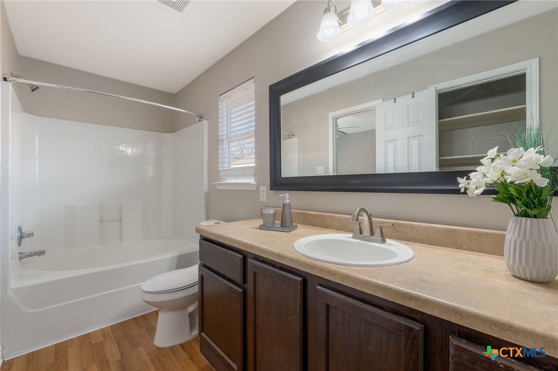 916 Freedom Drive Temple, TX 76502 - Photo 17 of 24 a bathroom with a sink a toilet and shower