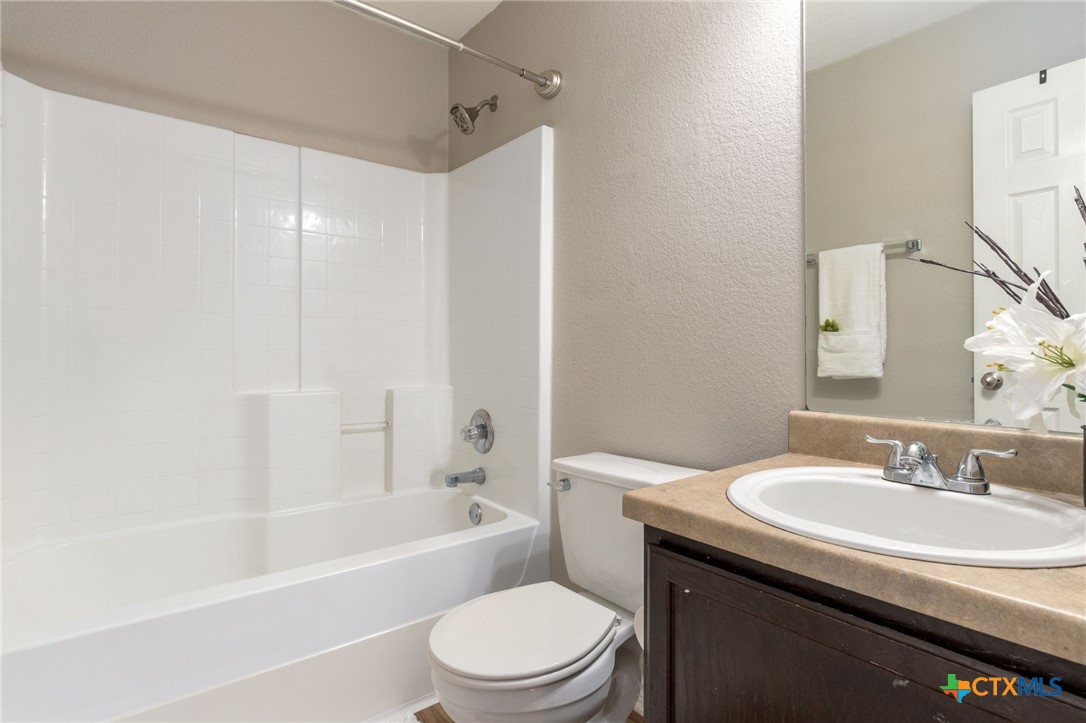 916 Freedom Drive Temple, TX 76502 - Photo 19 of 24 a bathroom with a sink a toilet and shower