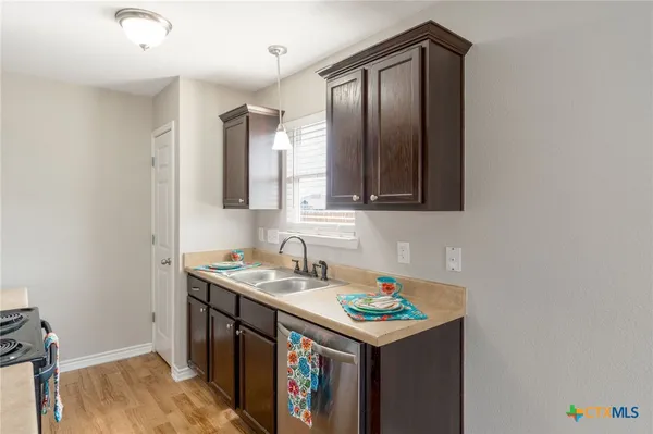a utility room with cabinets washer and dryer