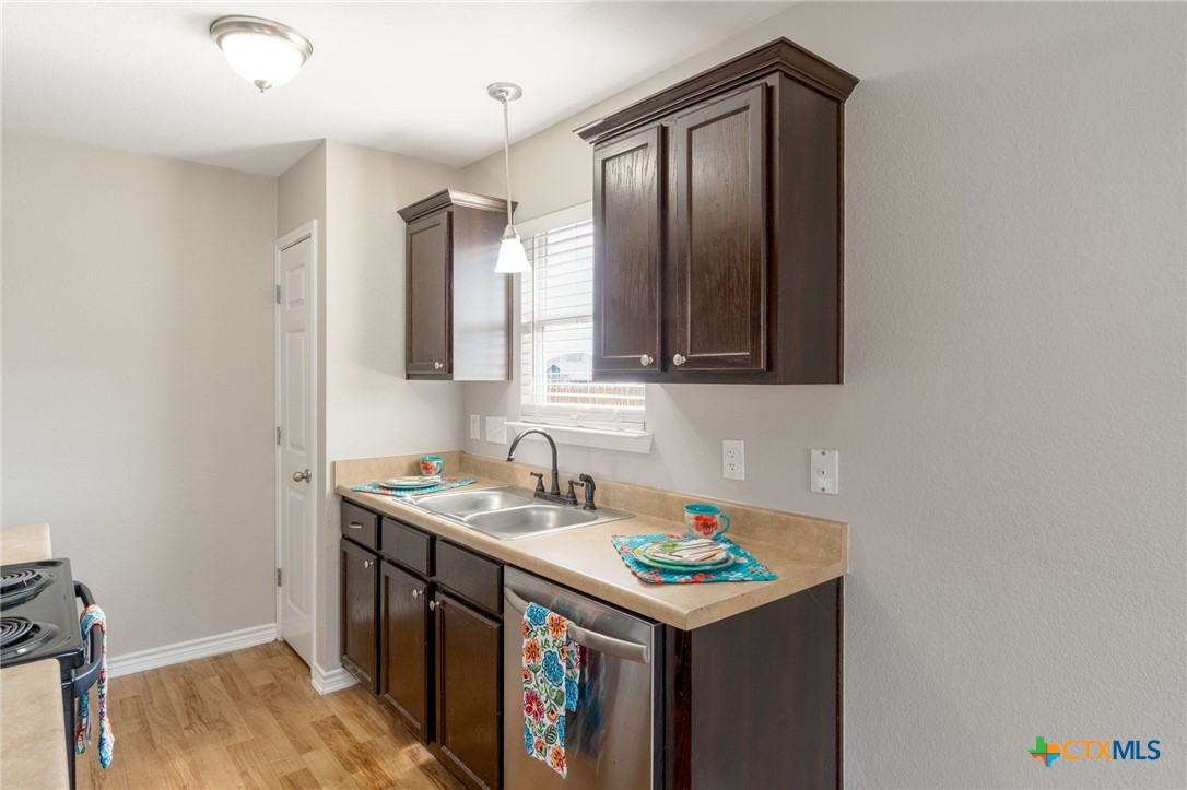 916 Freedom Drive Temple, TX 76502 - Photo 8 of 24 a utility room with cabinets washer and dryer